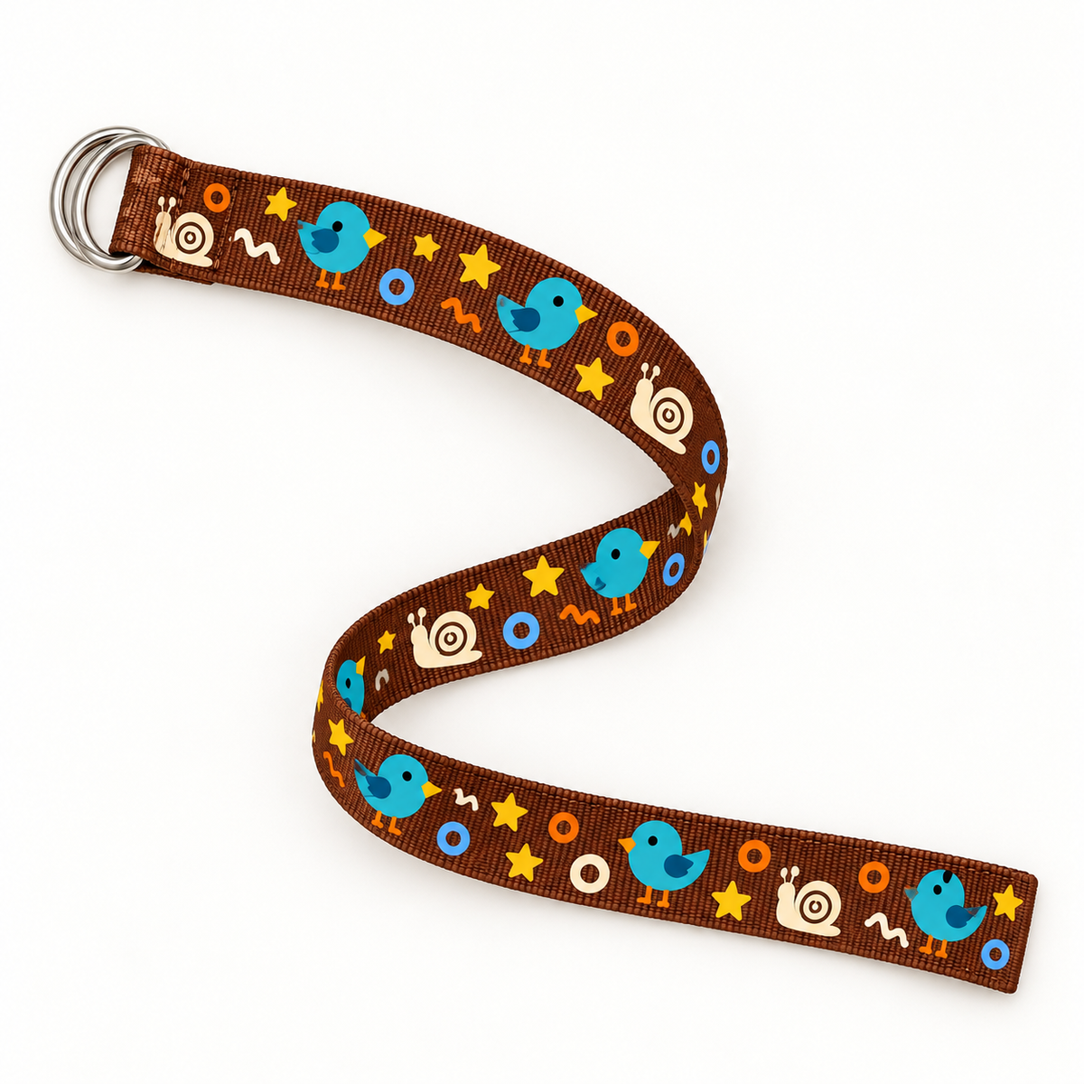 Brown nylon webbing belt in a full-length overhead curved layout, showing the double D-ring buckle, straight-cut end and original playful animal-and-shapes print on a warm-white background.