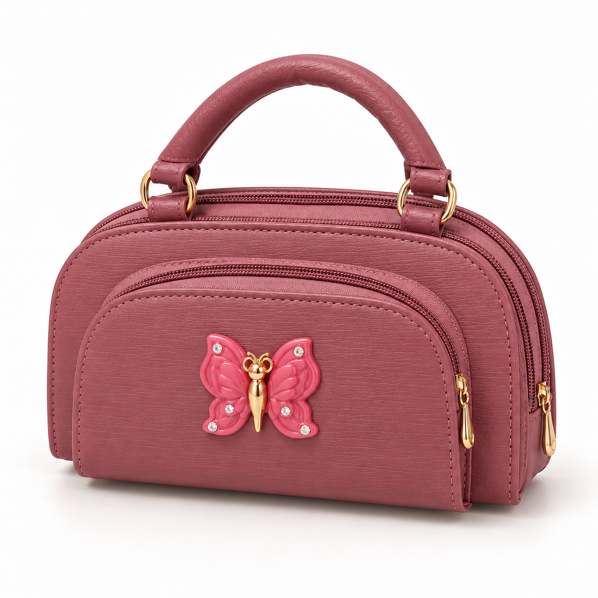 Pink top-handle handbag in three-quarter view with a fine textured surface, curved front zip pocket, butterfly ornament and gold-tone hardware.