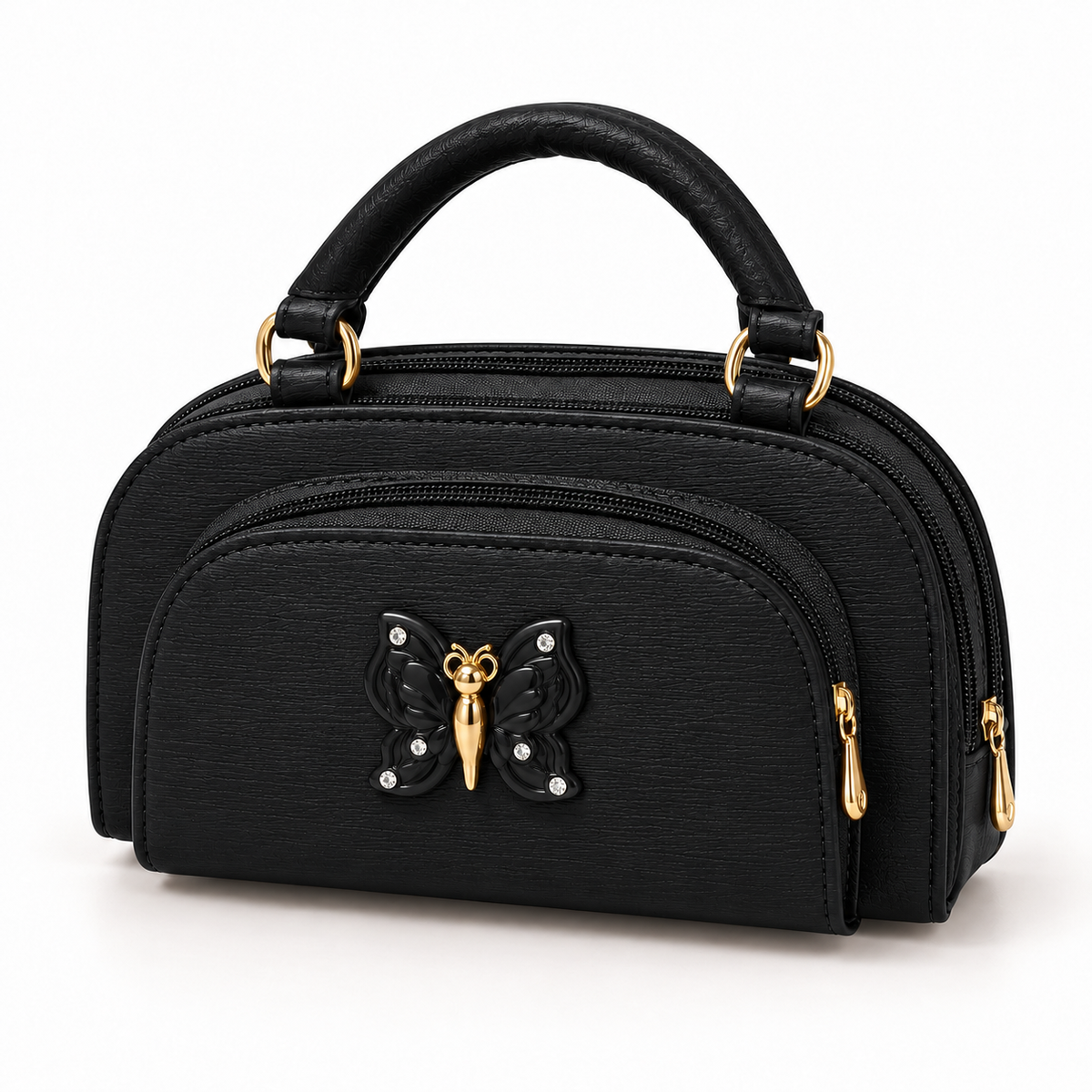 Black top-handle handbag in three-quarter view with a textured finish, arched zip pocket, black butterfly ornament and gold-tone rings and zip pulls.