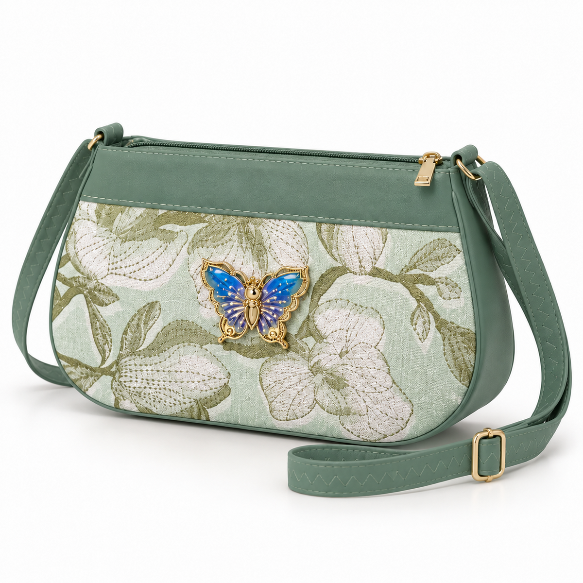 Sage green floral shoulder bag in three-quarter view with a blue and purple butterfly ornament, cream flowers, gold-tone hardware and buckled strap.