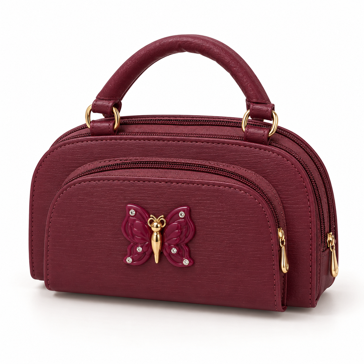 Burgundy handbag shown at a slight angle with a rounded handle, matching butterfly decoration, visible zippered sections and gold-tone hardware.