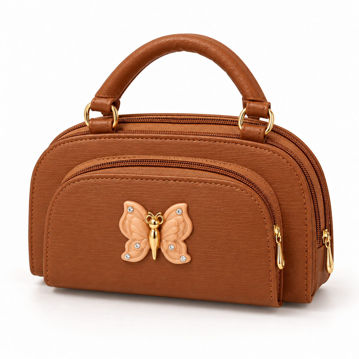 Tan handbag viewed from the front at an angle, showing a curved handle, layered zippered profile and peach butterfly ornament with gold-tone detail.