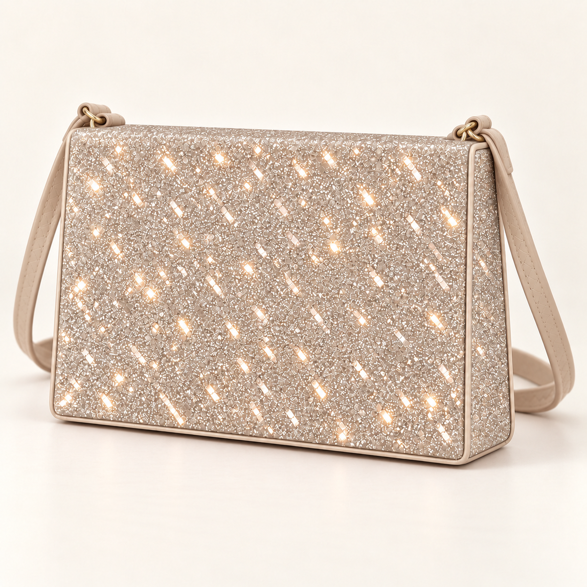 Three-quarter view of a champagne rectangular women's sling bag showing the sparkling glitter front panel, structured side and matching shoulder strap