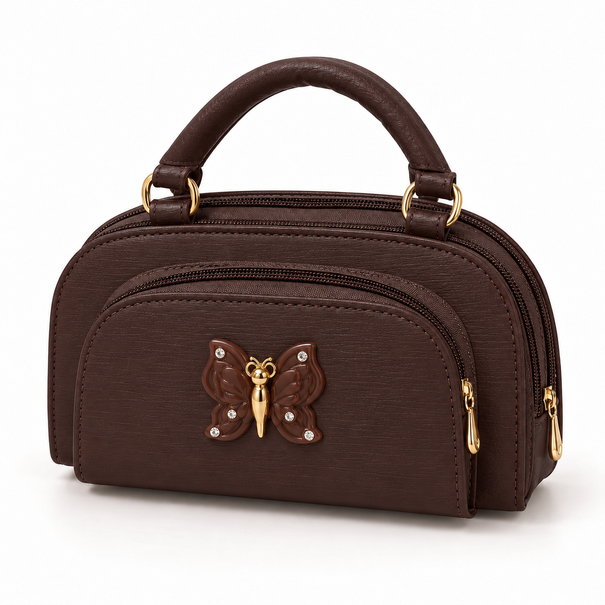 Dark brown handbag shown at a slight angle, featuring a rounded top handle, front zip pocket and brown butterfly detail with clear stone accents.